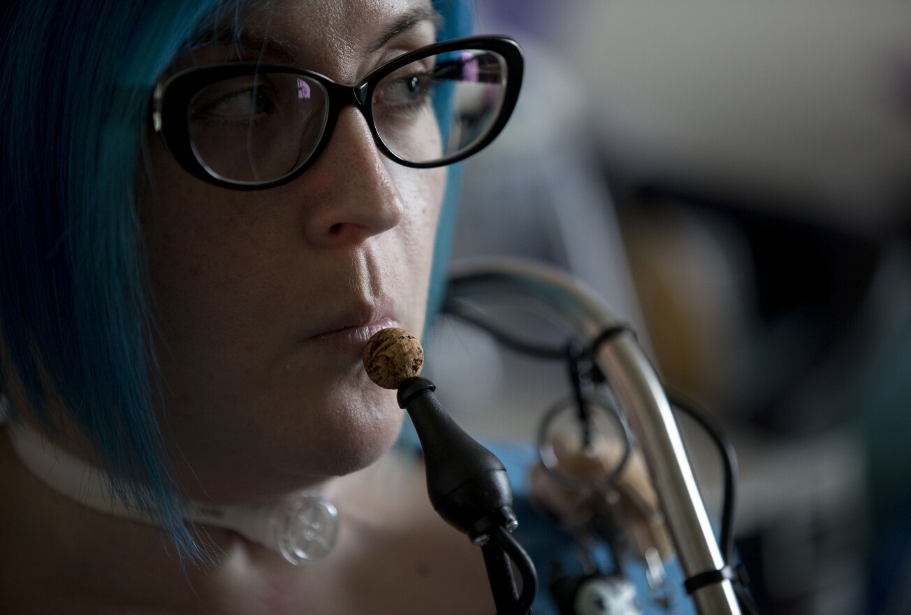 Ananda Bennett, a 30-year-old quadriplegic, uses a controller operated by her chin to work her motorized wheelchair and computer at her home in Greensboro, N.C.